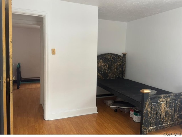 interior space with hardwood / wood-style flooring and a textured ceiling