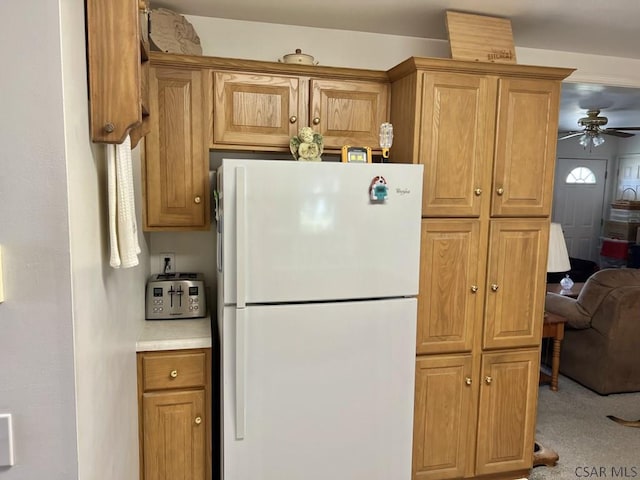 kitchen with white refrigerator, ceiling fan, and carpet flooring