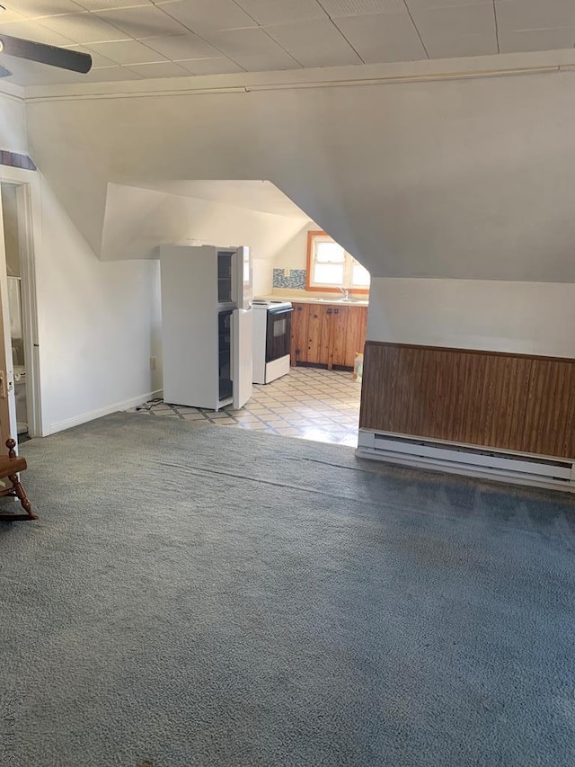 bonus room with ceiling fan, a baseboard radiator, and light colored carpet