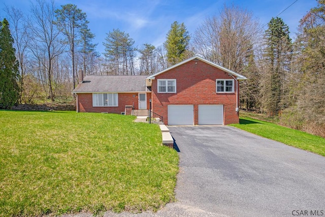260 S Somerset St, Stoystown, PA 15563 - split level home featuring aphalt driveway, a front lawn, brick siding, an attached garage, and a chimney