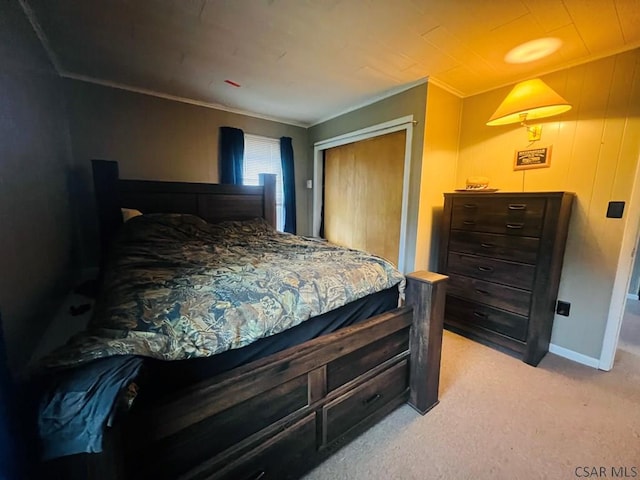 bedroom featuring ornamental molding, light carpet, and a closet