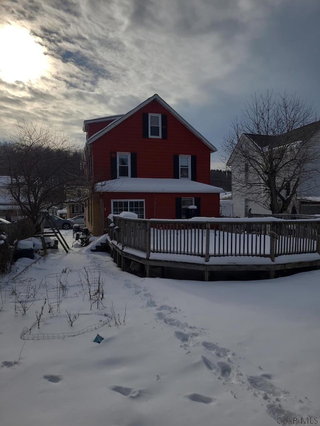 snow covered property featuring a wooden deck