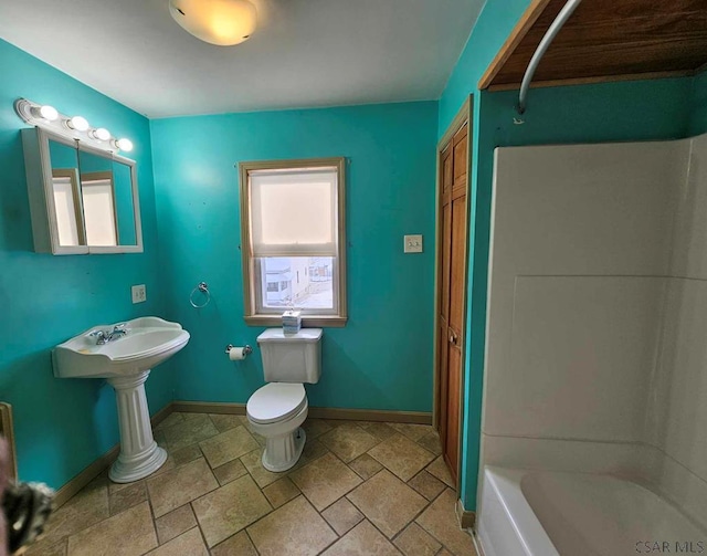 full bathroom with sink, shower / tub combination, and toilet