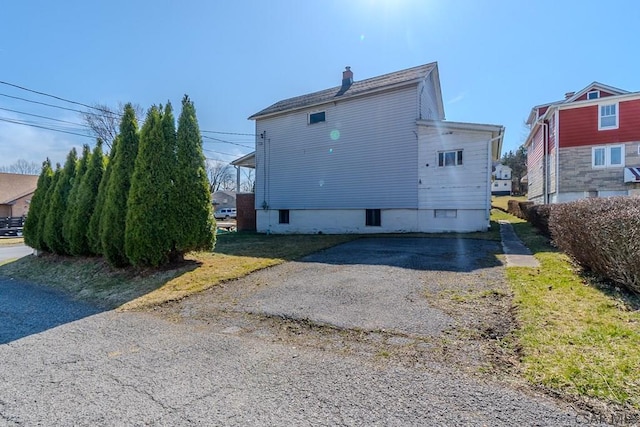 rear view of property featuring a chimney