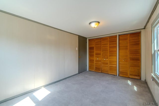 unfurnished bedroom with multiple closets