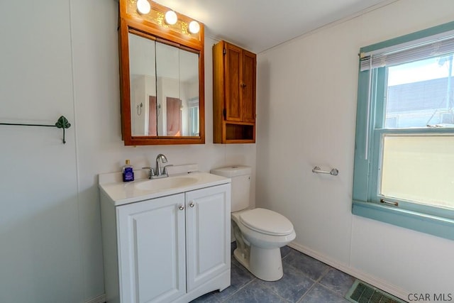 bathroom with visible vents, toilet, vanity, and baseboards