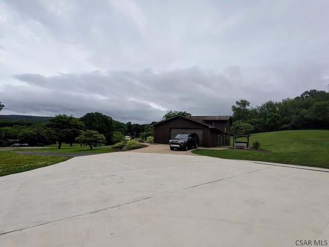 350 American Legion Rd, Latrobe, PA 15650 - view of side of home featuring concrete driveway, a yard, and an attached garage