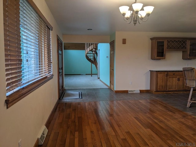 350 American Legion Rd, Latrobe, PA 15650 - unfurnished dining area featuring stairs, dark wood finished floors, and a chandelier