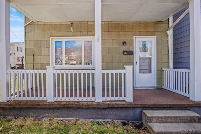 doorway to property featuring covered porch