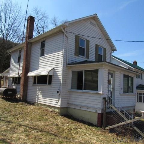 418 Main St, Vintondale, PA 15961 - view of front of home with entry steps, a chimney, and heating fuel