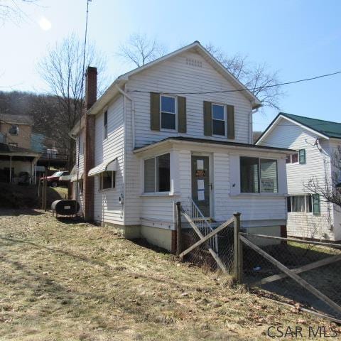 418 Main St, Vintondale, PA 15961 - view of front of property featuring fence and a chimney