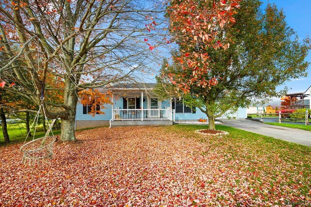 view of front of property featuring a porch and a garage