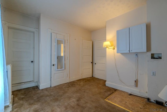 interior space featuring baseboards and carpet floors