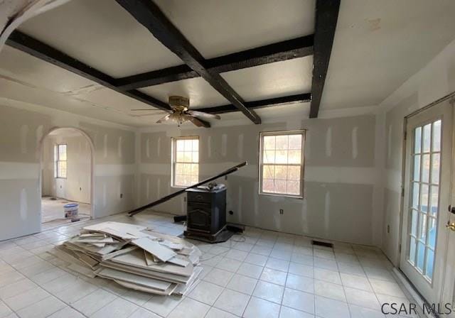 unfurnished room featuring ceiling fan, coffered ceiling, light tile patterned floors, and beam ceiling