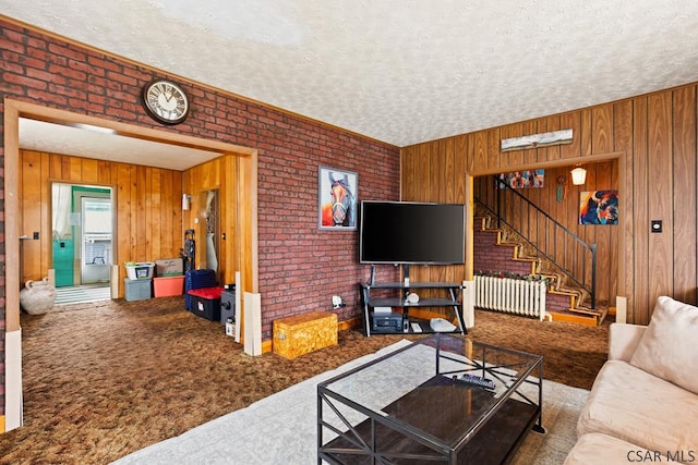 540 S Center Ave, Somerset, PA 15501 - living area with carpet, radiator heating unit, stairs, a textured ceiling, and wood walls