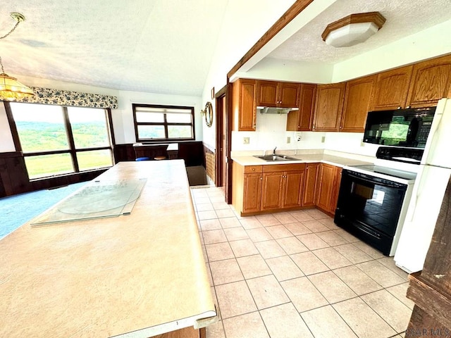 152 Aviator Ln, Friedens, PA 15541 - kitchen with black appliances, a textured ceiling, wainscoting, light countertops, and brown cabinetry
