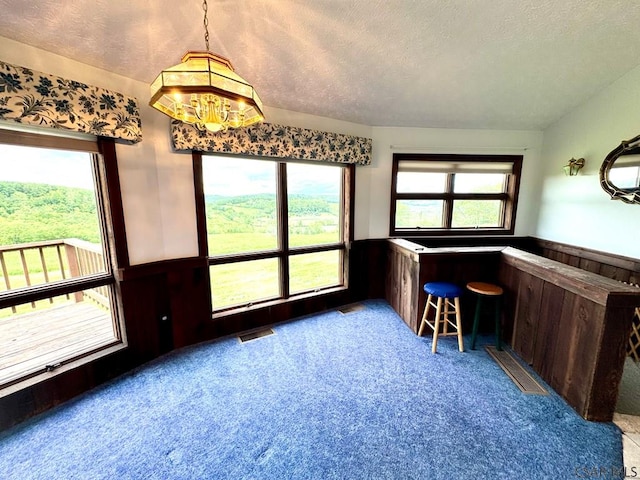 152 Aviator Ln, Friedens, PA 15541 - carpeted dining space with a textured ceiling, a wainscoted wall, and bar area
