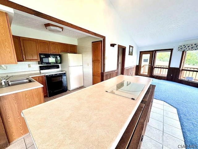 152 Aviator Ln, Friedens, PA 15541 - kitchen with white appliances, a textured ceiling, wainscoting, light countertops, and light colored carpet