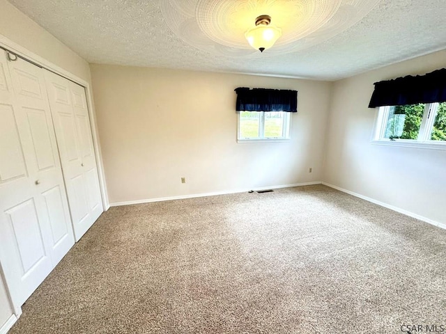 152 Aviator Ln, Friedens, PA 15541 - unfurnished bedroom with multiple windows, a closet, a textured ceiling, and carpet