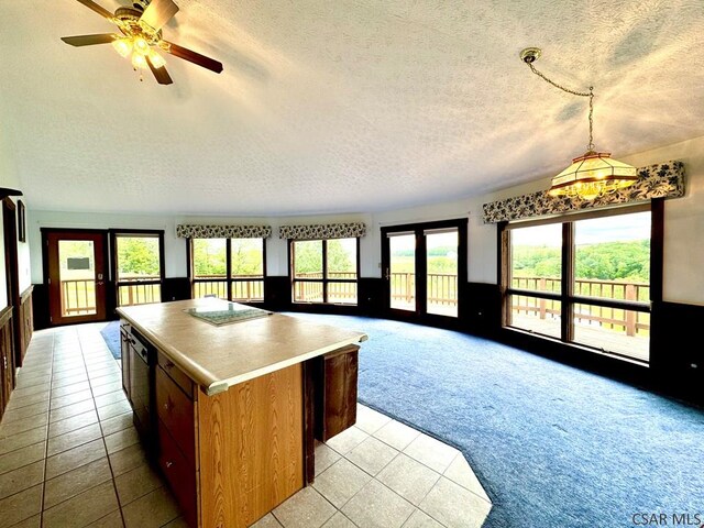 152 Aviator Ln, Friedens, PA 15541 - kitchen featuring light colored carpet, open floor plan, a textured ceiling, a kitchen island, and light tile patterned floors
