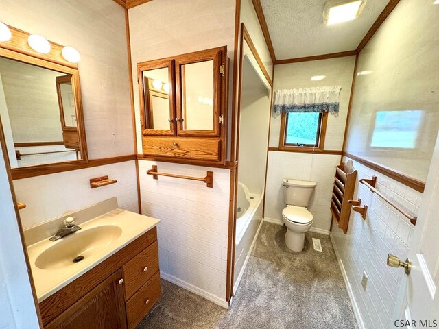 152 Aviator Ln, Friedens, PA 15541 - bathroom with tile walls, vanity, a textured ceiling, ornamental molding, and wainscoting