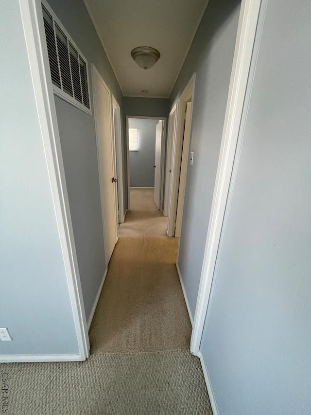 hallway with light colored carpet