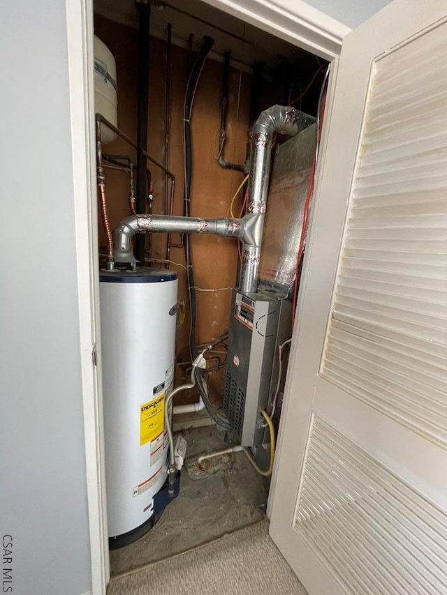 utility room featuring water heater