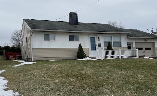 rear view of house featuring a garage, a lawn, central air condition unit, and a porch