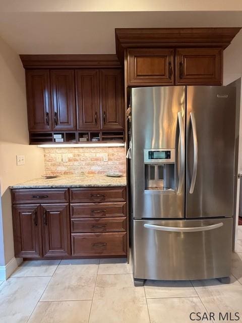 kitchen with stainless steel fridge with ice dispenser, tasteful backsplash, light stone countertops, and light tile patterned flooring