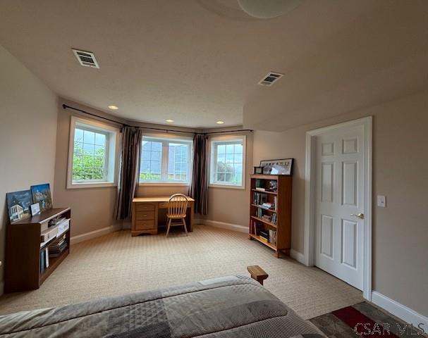 sitting room featuring baseboards, light carpet, and recessed lighting