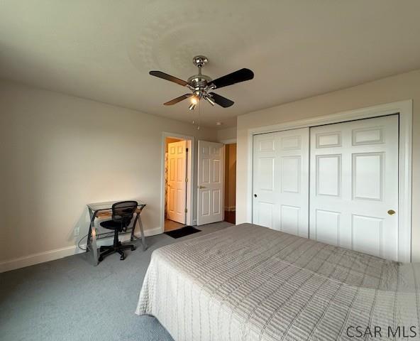 carpeted bedroom featuring baseboards, a closet, and a ceiling fan