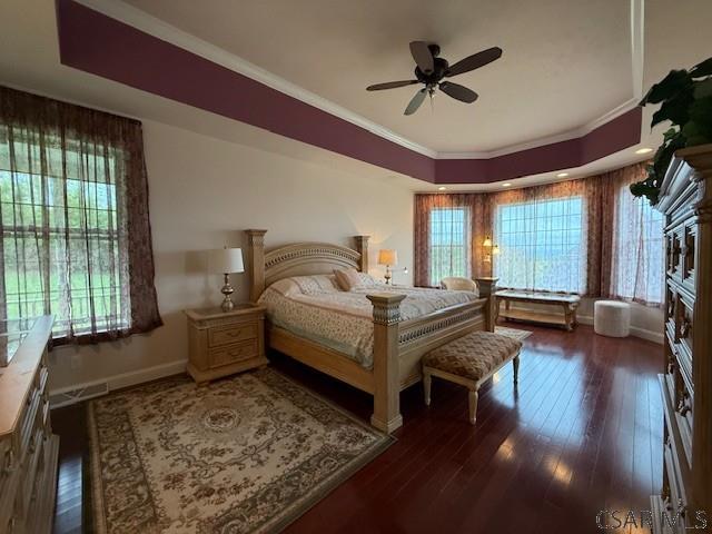 bedroom with ornamental molding, wood-type flooring, and baseboards