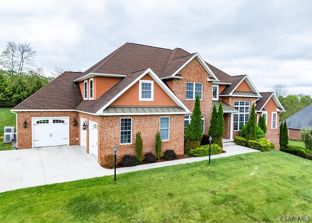 view of front of house featuring a standing seam roof, a garage, a front yard, and driveway