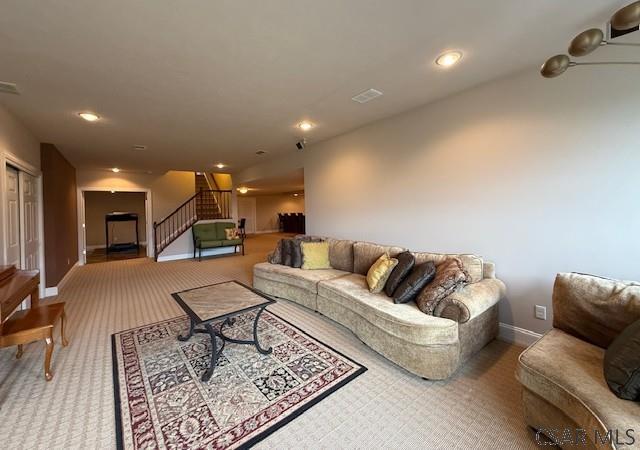 living area featuring stairway, carpet floors, baseboards, and recessed lighting