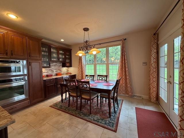 dining area featuring recessed lighting and french doors