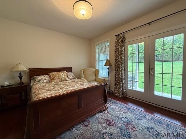 bedroom featuring french doors, wood finished floors, and access to outside