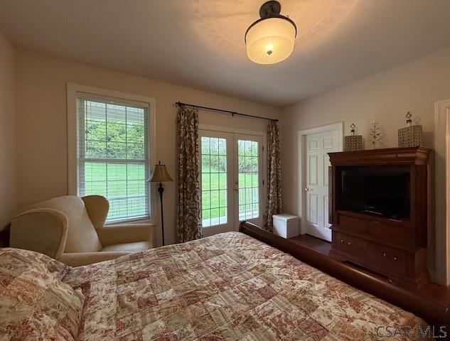 bedroom with multiple windows and access to outside