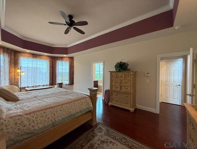bedroom with crown molding, baseboards, dark wood finished floors, and ceiling fan