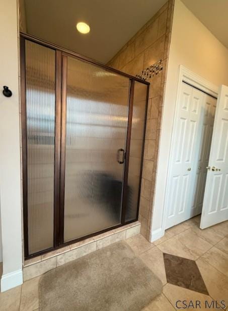bathroom with a shower stall, baseboards, tile patterned floors, and recessed lighting
