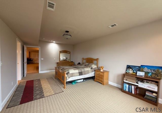 bedroom featuring carpet floors and baseboards