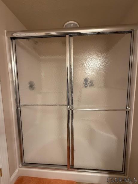 full bathroom featuring a stall shower