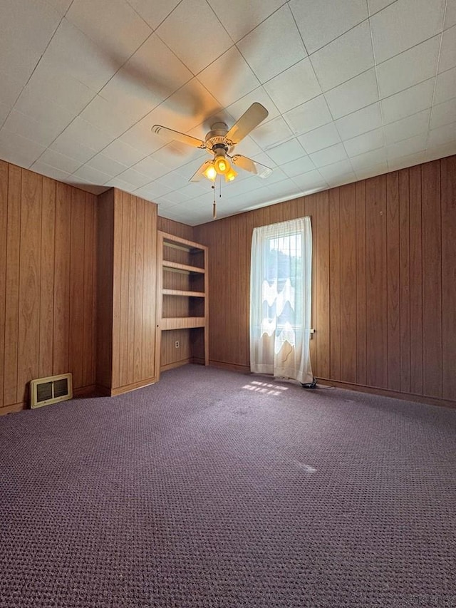R1249 Main St, Johnstown, PA 15909 - unfurnished room with wood walls, a ceiling fan, carpet floors, and built in features