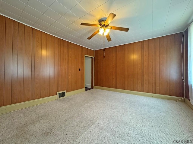 R1249 Main St, Johnstown, PA 15909 - spare room with ceiling fan, carpet floors, and wooden walls