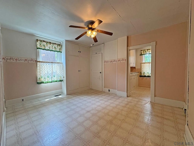 R1249 Main St, Johnstown, PA 15909 - unfurnished bedroom featuring light flooring, connected bathroom, a ceiling fan, and a closet