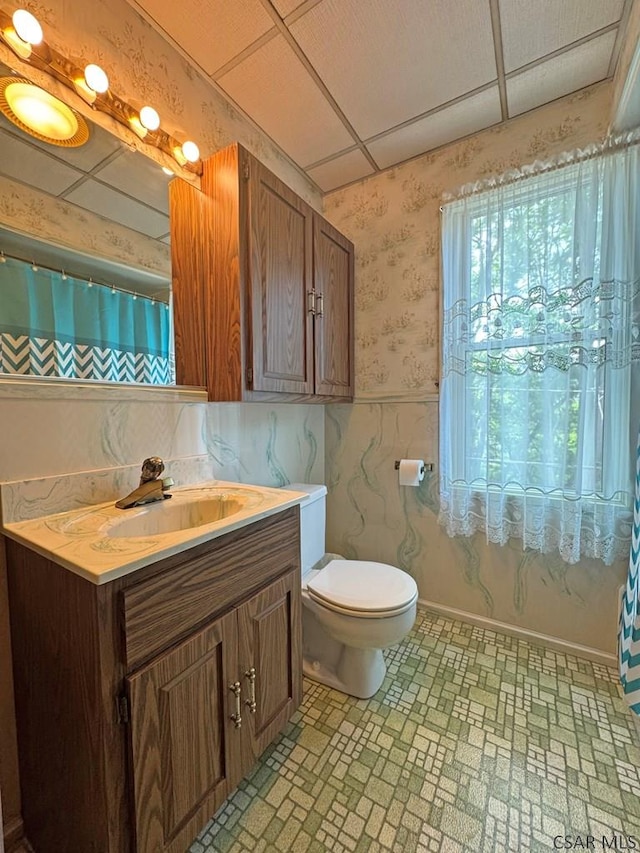 R1249 Main St, Johnstown, PA 15909 - full bath featuring wallpapered walls, vanity, wainscoting, and brick patterned flooring