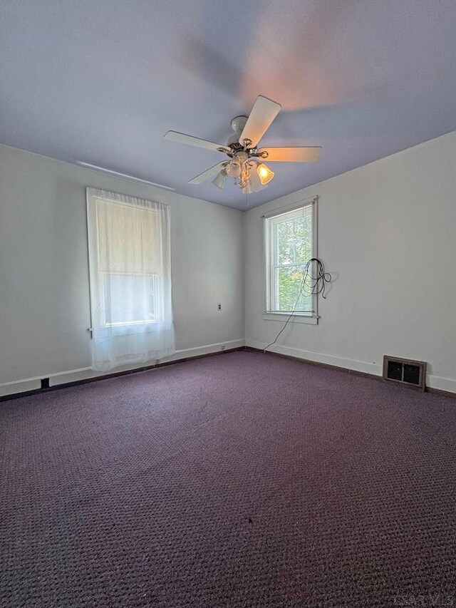 R1249 Main St, Johnstown, PA 15909 - unfurnished room with dark carpet and a ceiling fan