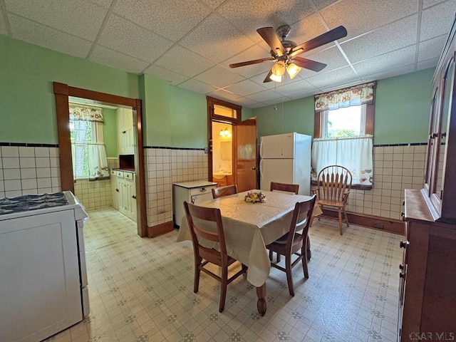 R1249 Main St, Johnstown, PA 15909 - dining space with tile walls, a wainscoted wall, light flooring, plenty of natural light, and ceiling fan