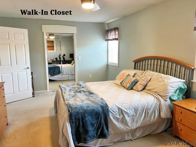 bedroom featuring a closet and light colored carpet