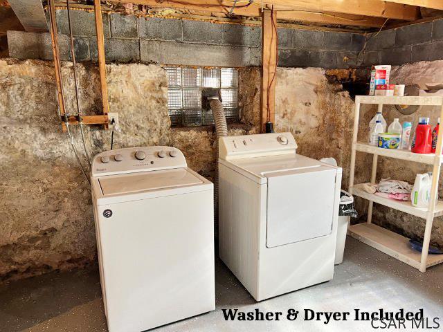 laundry area with washing machine and clothes dryer and laundry area