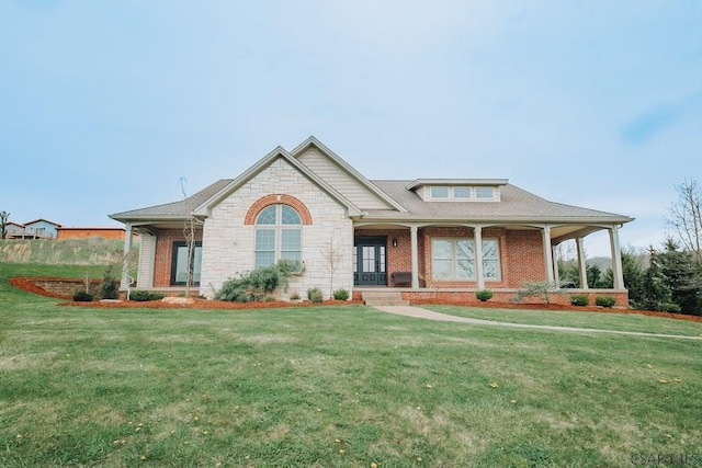 view of front of property featuring covered porch and a front yard